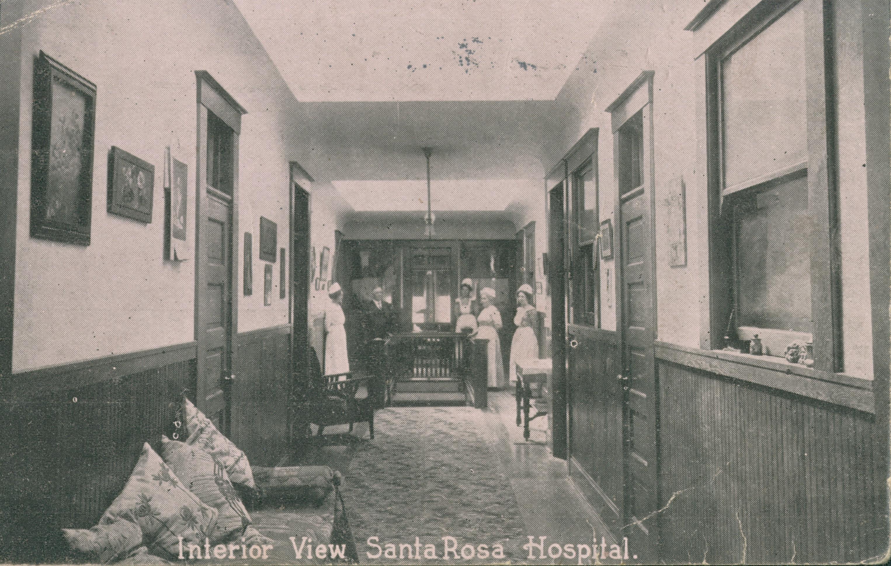 Shows several nurses standing in an interior hallway at Santa Rosa hospital.